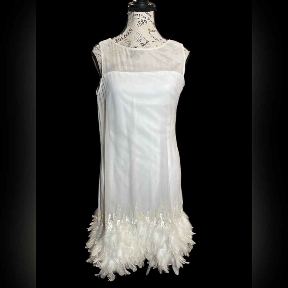 Twotwinstyle dress with a straight silhouette, and a real feather trim.